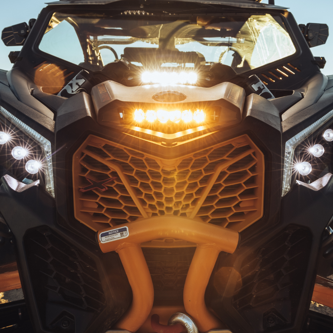 6 inch amber led light bar mounted as a shock tower light on a can-am maverick